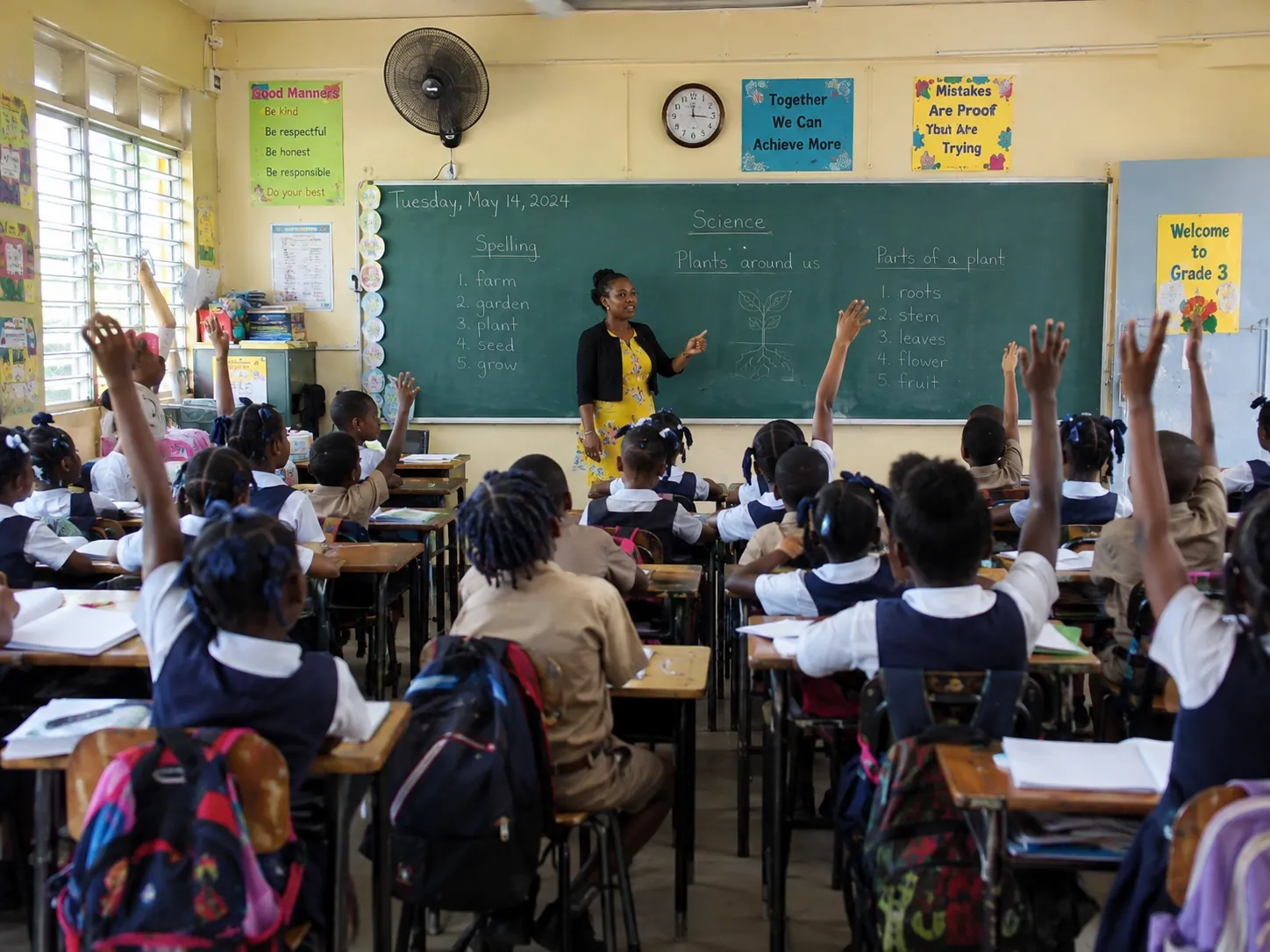 Teacher at the chalkboard with a class of primary students